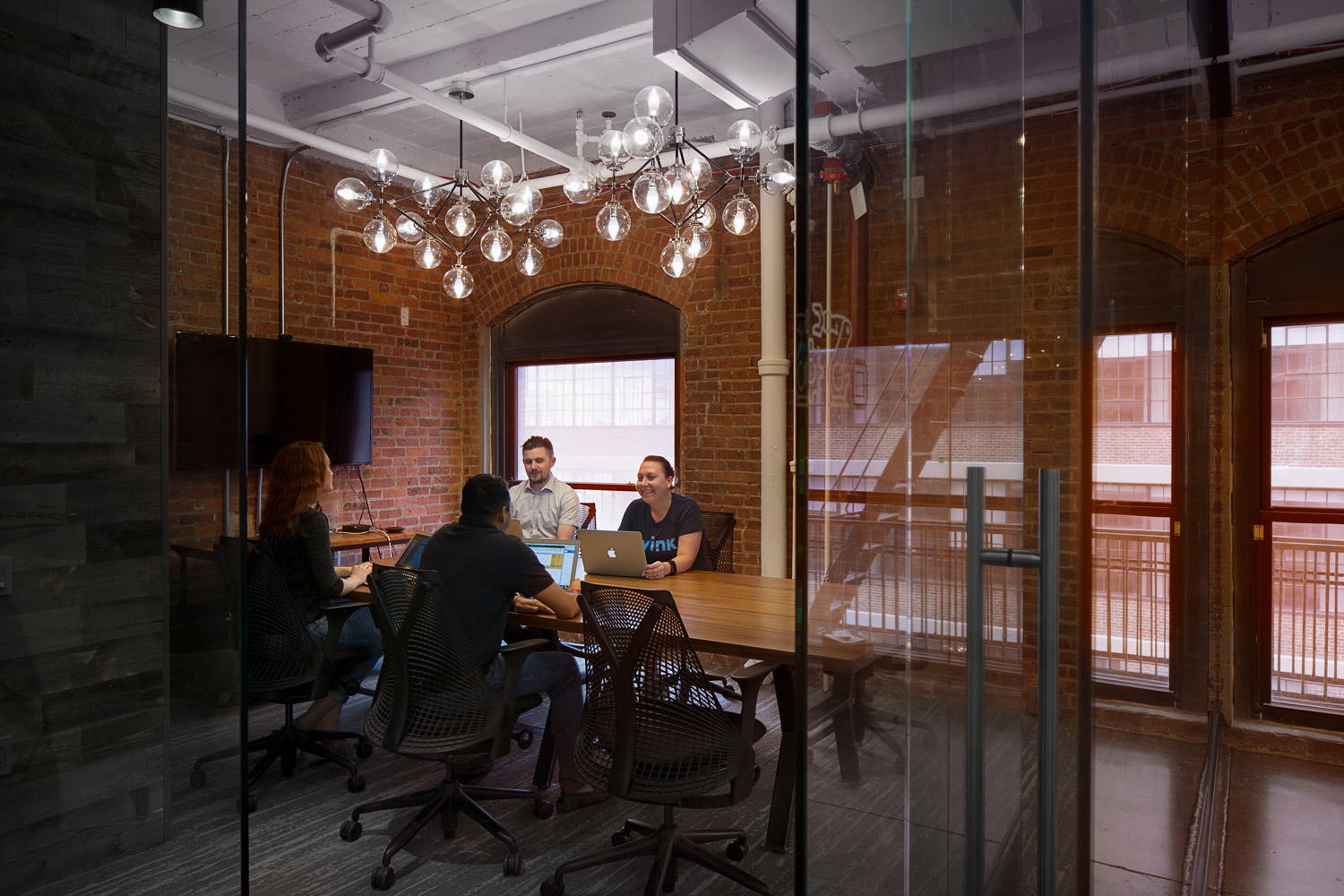 A photo of Wink employees in a conference room for a meeting